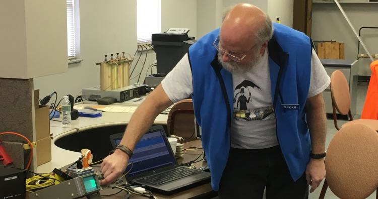 Mitch K9ZXO using an oscillioscope to check for overmodulation of his signal